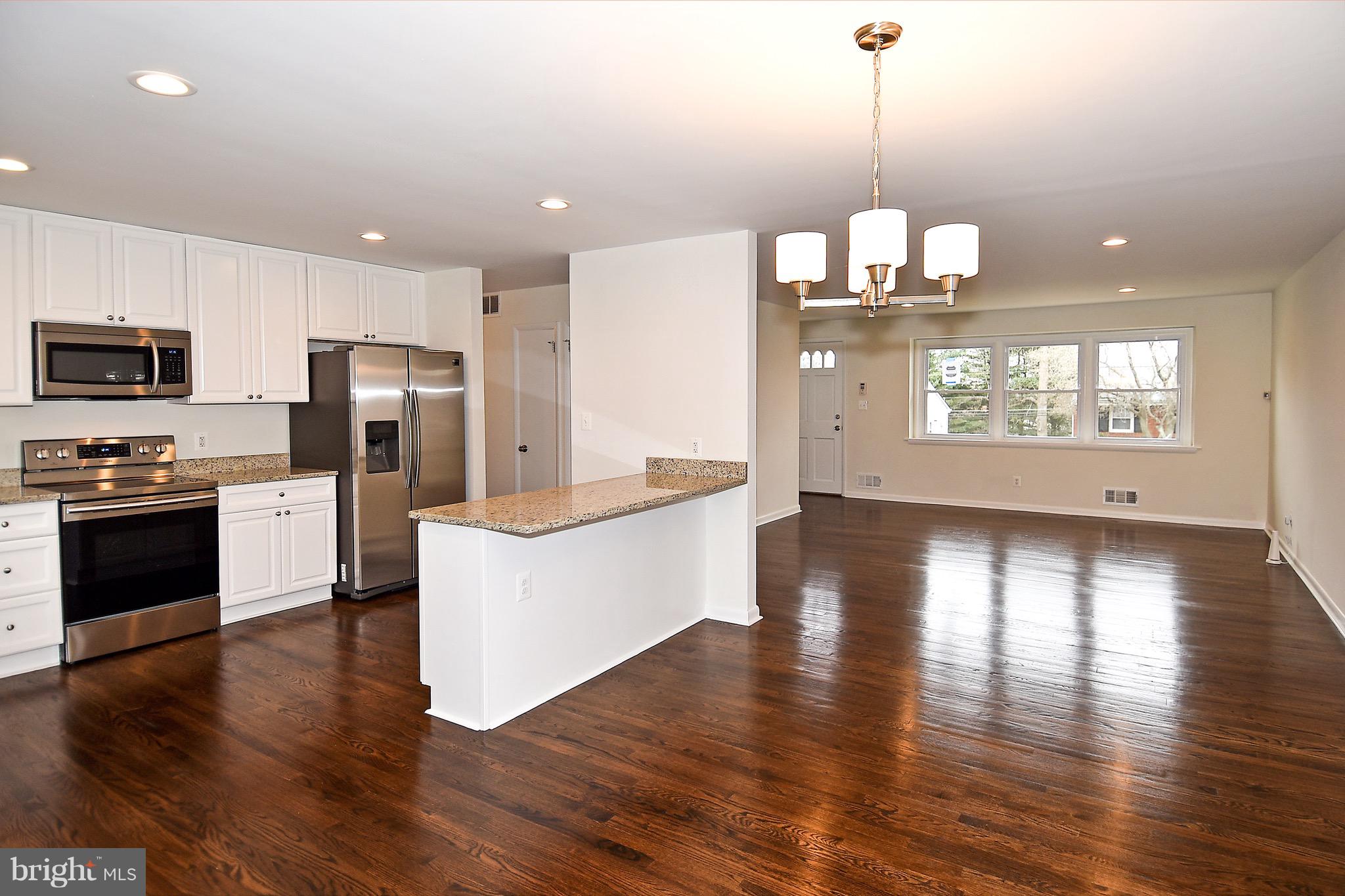 8609 Woodspring Road Randallstown, MD 21133 - Photo 4 of 43 a kitchen with stainless steel appliances a refrigerator a stove top oven and sink