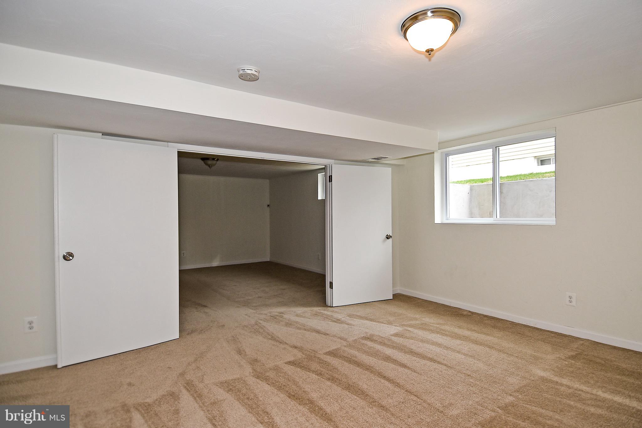 8609 Woodspring Road Randallstown, MD 21133 - Photo 34 of 43 a view of an empty room with wooden floor and a window