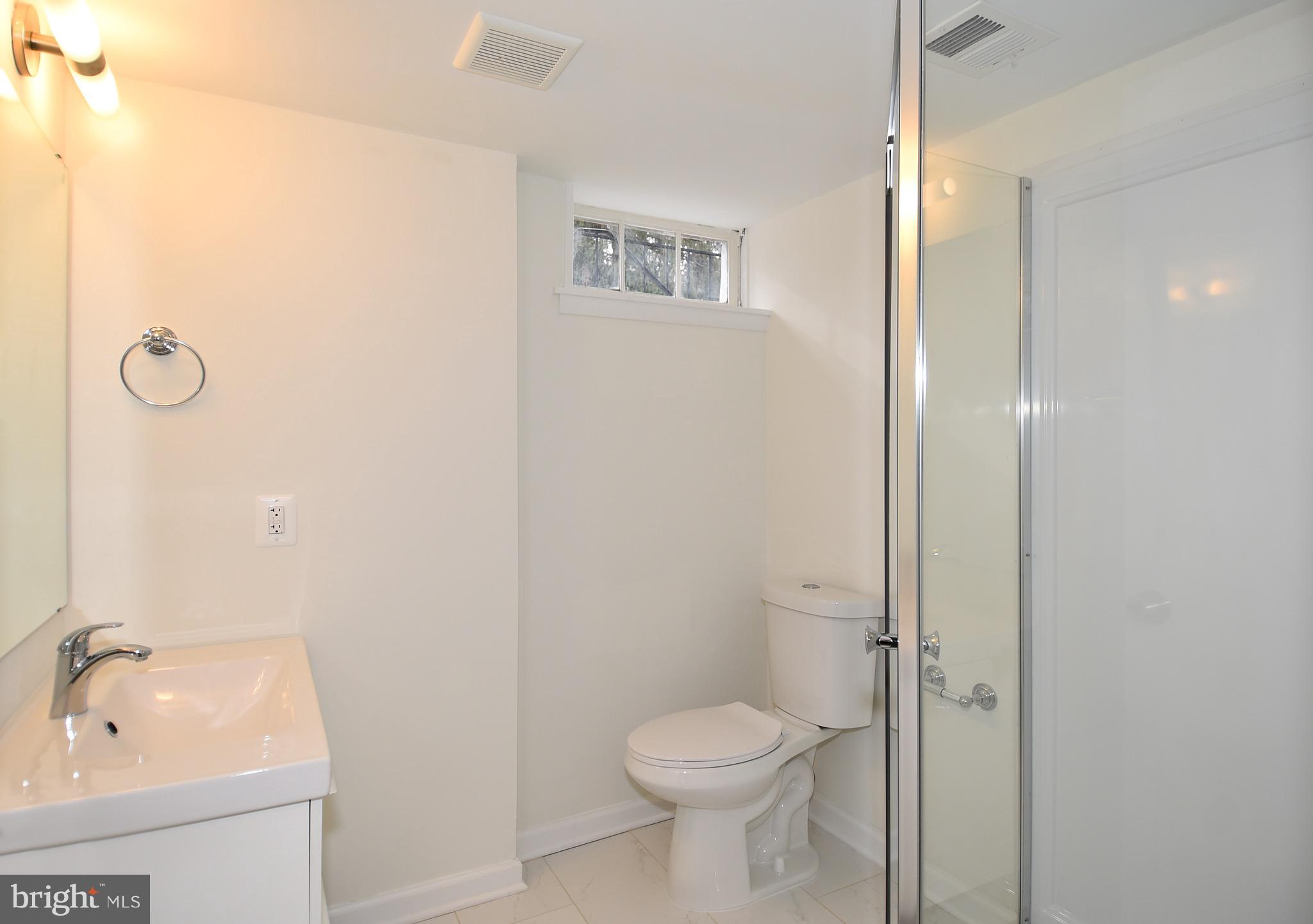 8609 Woodspring Road Randallstown, MD 21133 - Photo 36 of 43 a bathroom with a toilet sink and shower