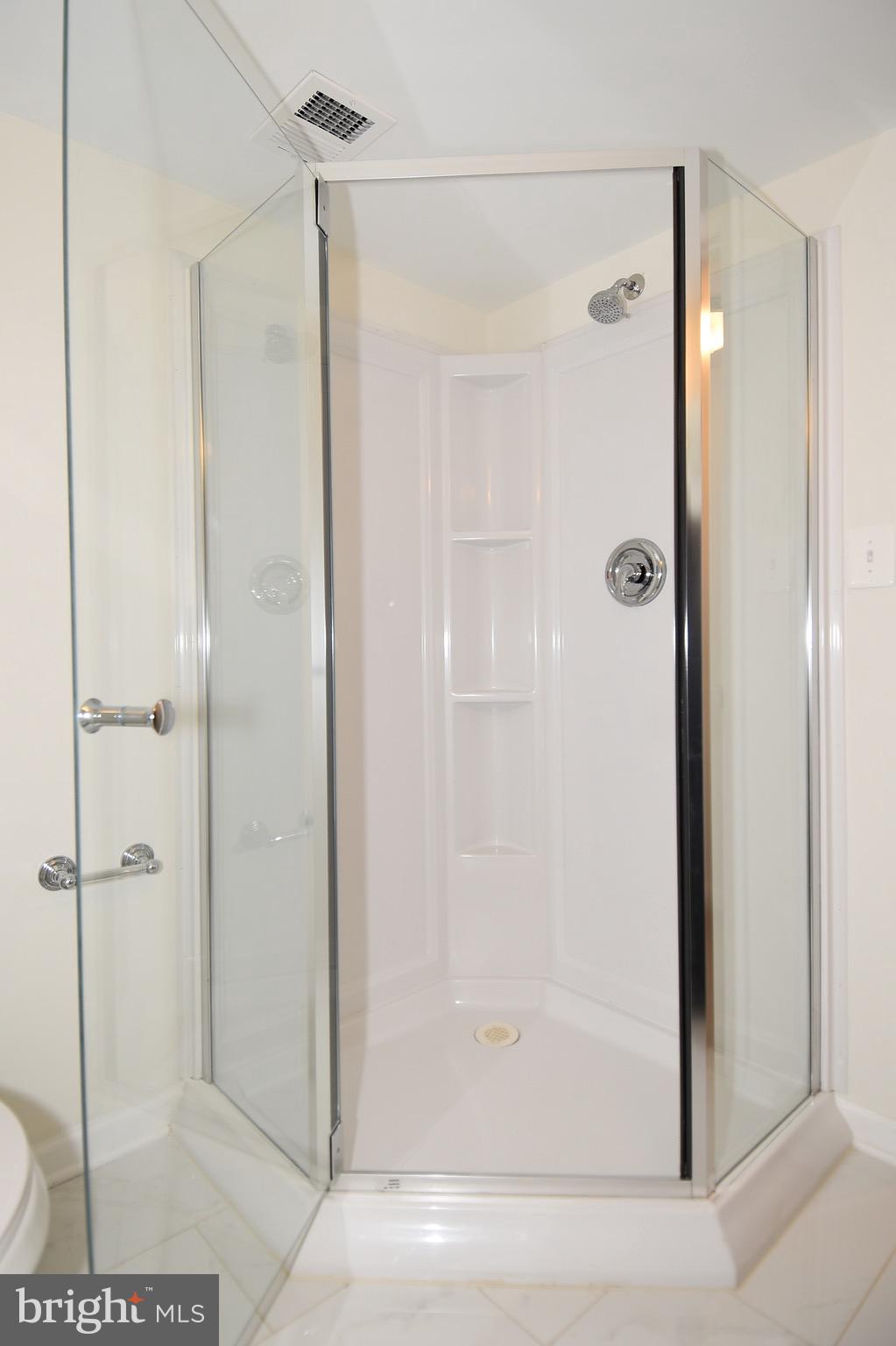 8609 Woodspring Road Randallstown, MD 21133 - Photo 37 of 43 a bathroom with a shower and a glass door