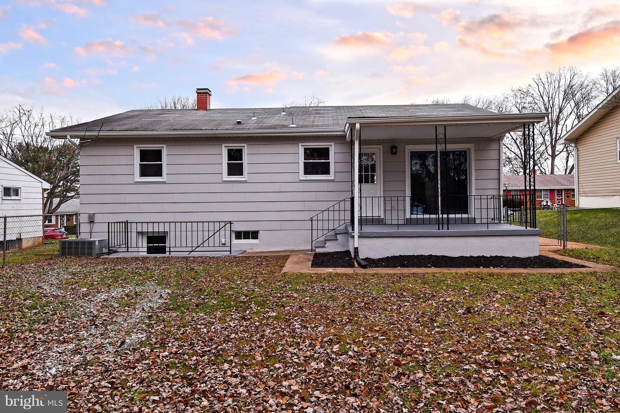 8609 Woodspring Road Randallstown, MD 21133 - Photo 41 of 43 a front view of a house with a garden