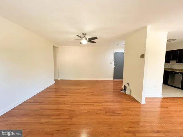 a view of a kitchen with wooden floor and a ceiling fan