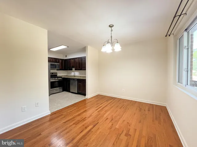 a view of kitchen with sink and wooden floor