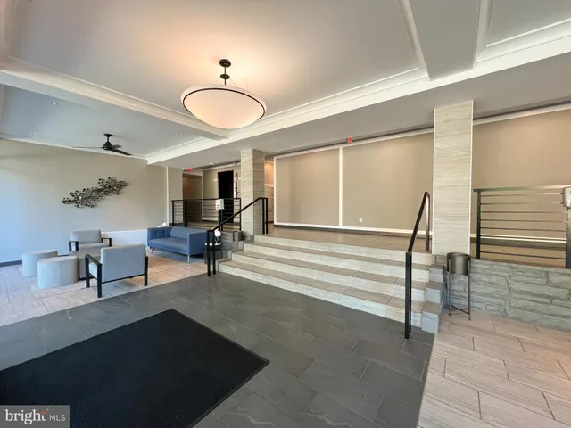 a view of a livingroom with furniture and a window