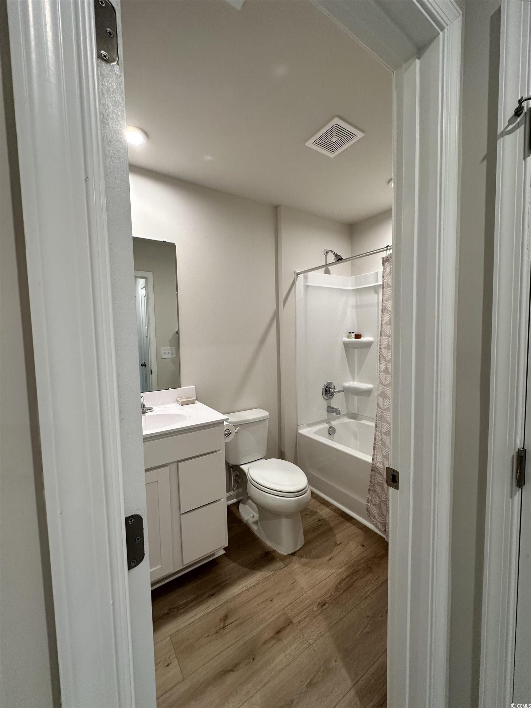 157 B Villa Grande Street, Unit B Myrtle Beach, SC 29579 - Photo 12 of 28 Bathroom with shower / bathtub combination with curtain, vanity, and light wood finished floors