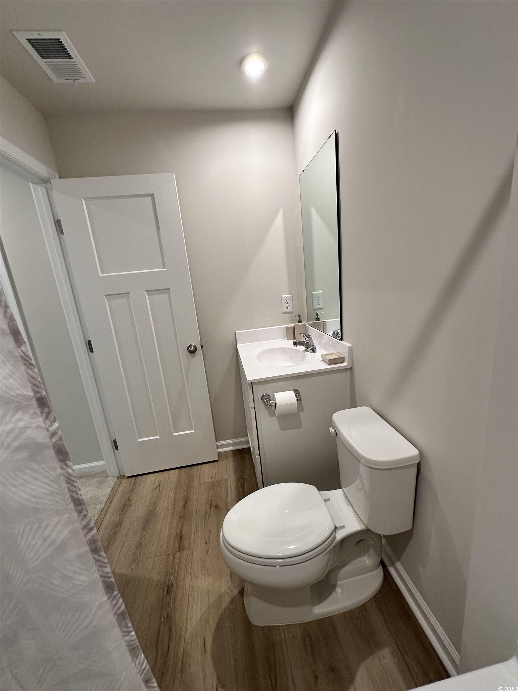157 B Villa Grande Street, Unit B Myrtle Beach, SC 29579 - Photo 13 of 28 Bathroom featuring light wood-style flooring and vanity
