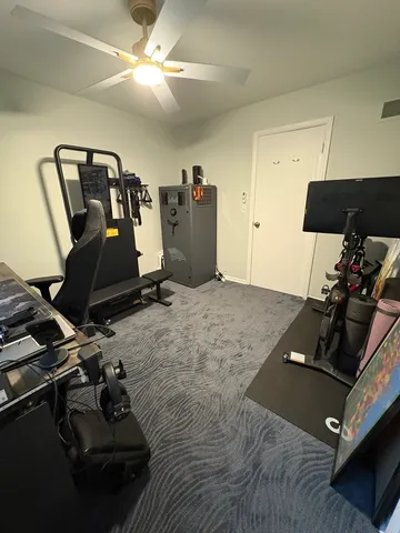 a room with gym equipment and wooden floor