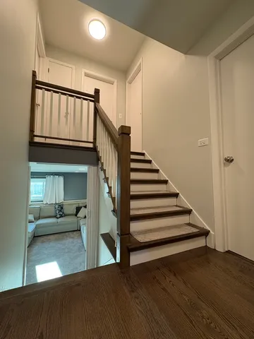 a view of entryway and hall with wooden floor