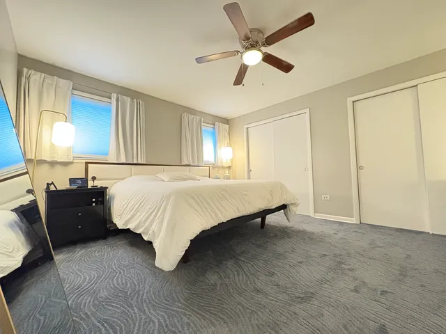 a bed room with a bed and a chandelier