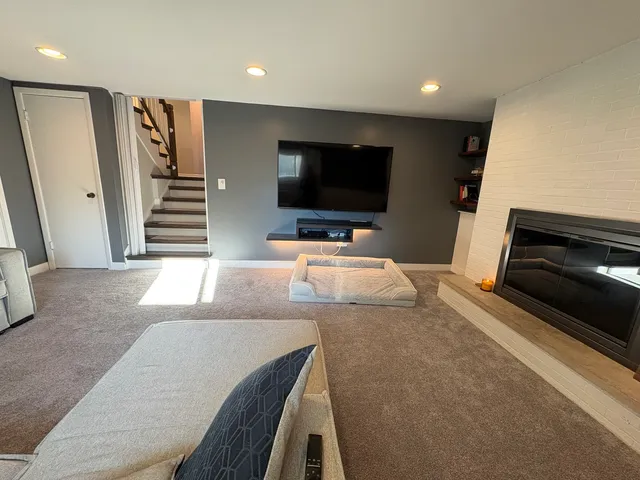 a living room with furniture and a flat screen tv