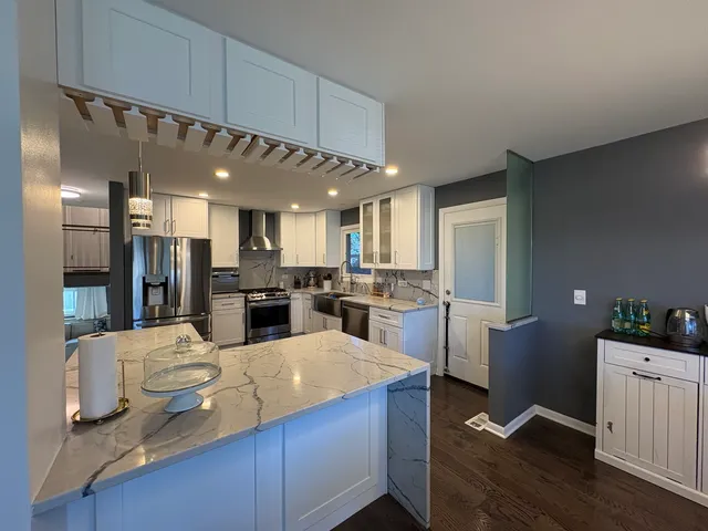 a large kitchen with a table and chairs