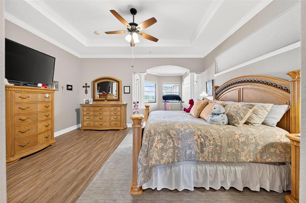 19850 Sugarloaf Mountain Road Clermont, FL 34715 - Photo 19 of 100 a bedroom with a large bed a flat tv screen and a dresser