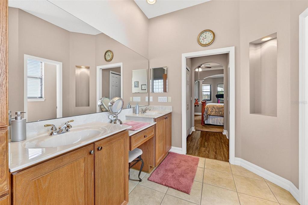 19850 Sugarloaf Mountain Road Clermont, FL 34715 - Photo 27 of 100 a spacious bathroom with a granite countertop sink and a mirror
