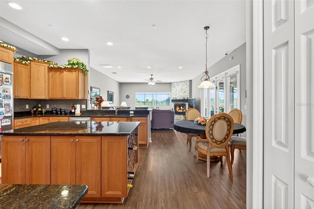 19850 Sugarloaf Mountain Road Clermont, FL 34715 - Photo 31 of 100 a kitchen with stainless steel appliances granite countertop a table chairs sink and wooden floor