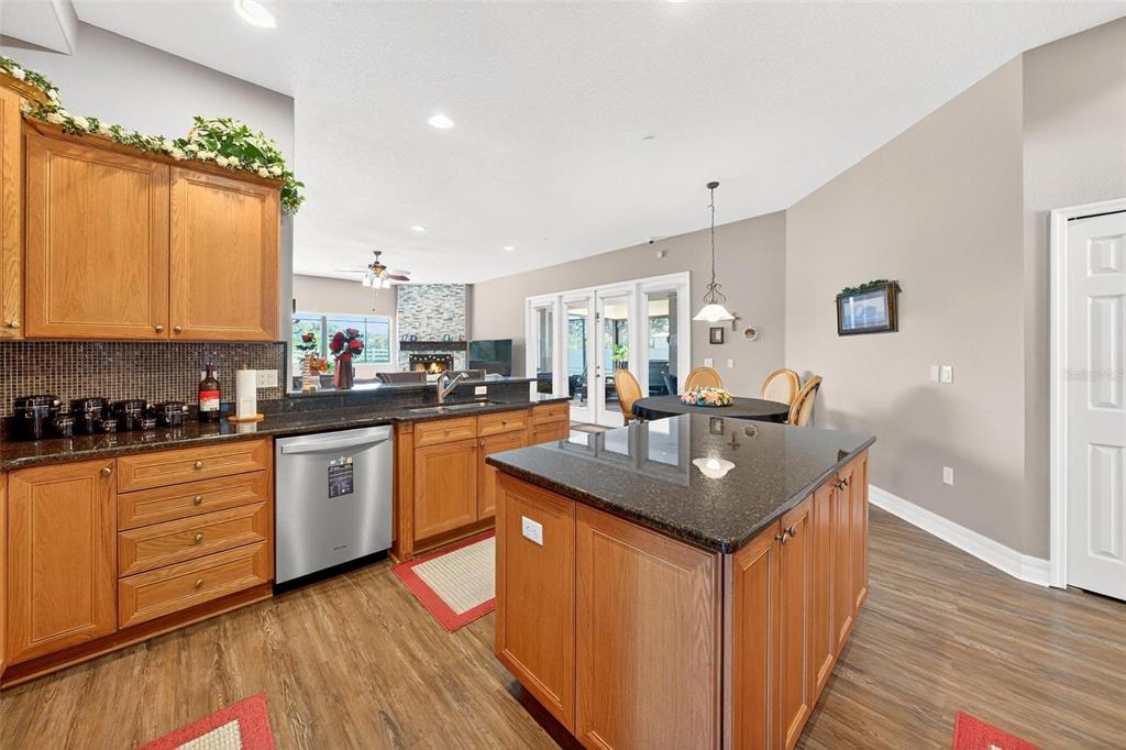 19850 Sugarloaf Mountain Road Clermont, FL 34715 - Photo 33 of 100 a kitchen with granite countertop a sink stove cabinets and wooden floor