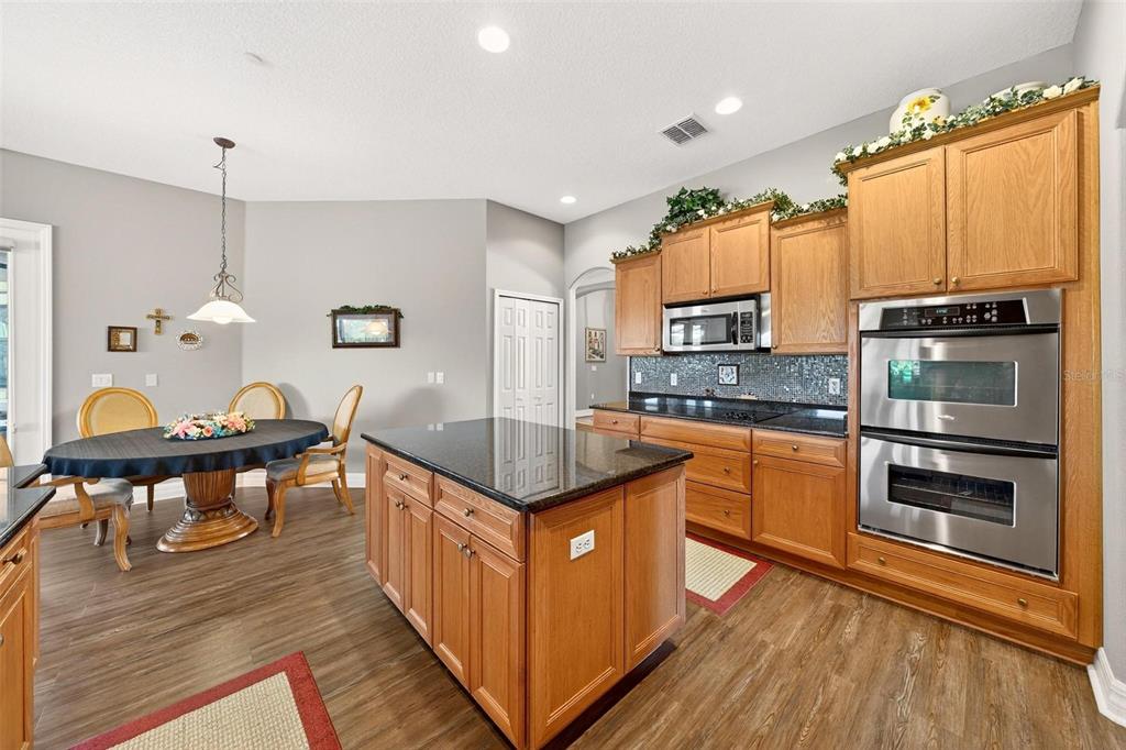19850 Sugarloaf Mountain Road Clermont, FL 34715 - Photo 34 of 100 a kitchen with stainless steel appliances granite countertop a stove a sink dishwasher and a refrigerator
