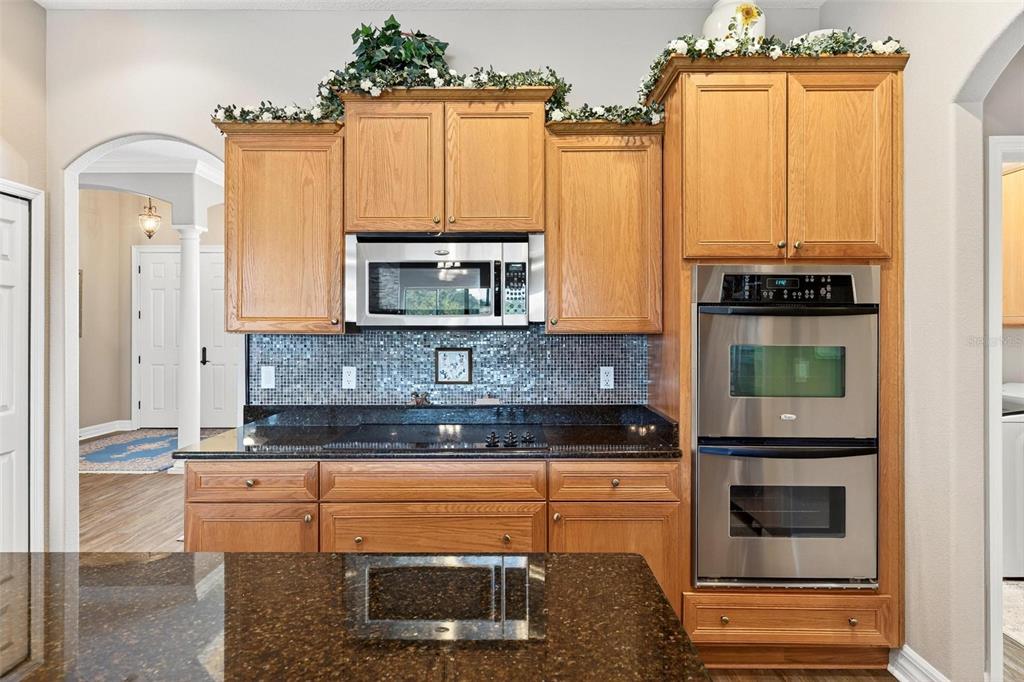 19850 Sugarloaf Mountain Road Clermont, FL 34715 - Photo 35 of 100 a kitchen with stainless steel appliances granite countertop a stove and a microwave