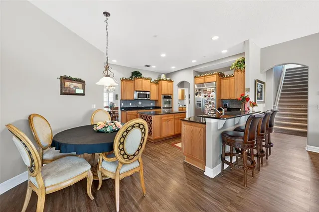 a open kitchen with white cabinets and wooden floor
