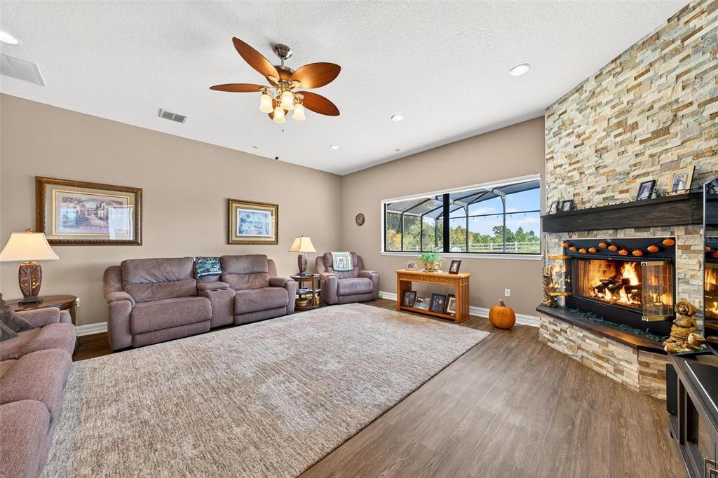 19850 Sugarloaf Mountain Road Clermont, FL 34715 - Photo 50 of 100 a living room with furniture and a flat screen tv with a large window