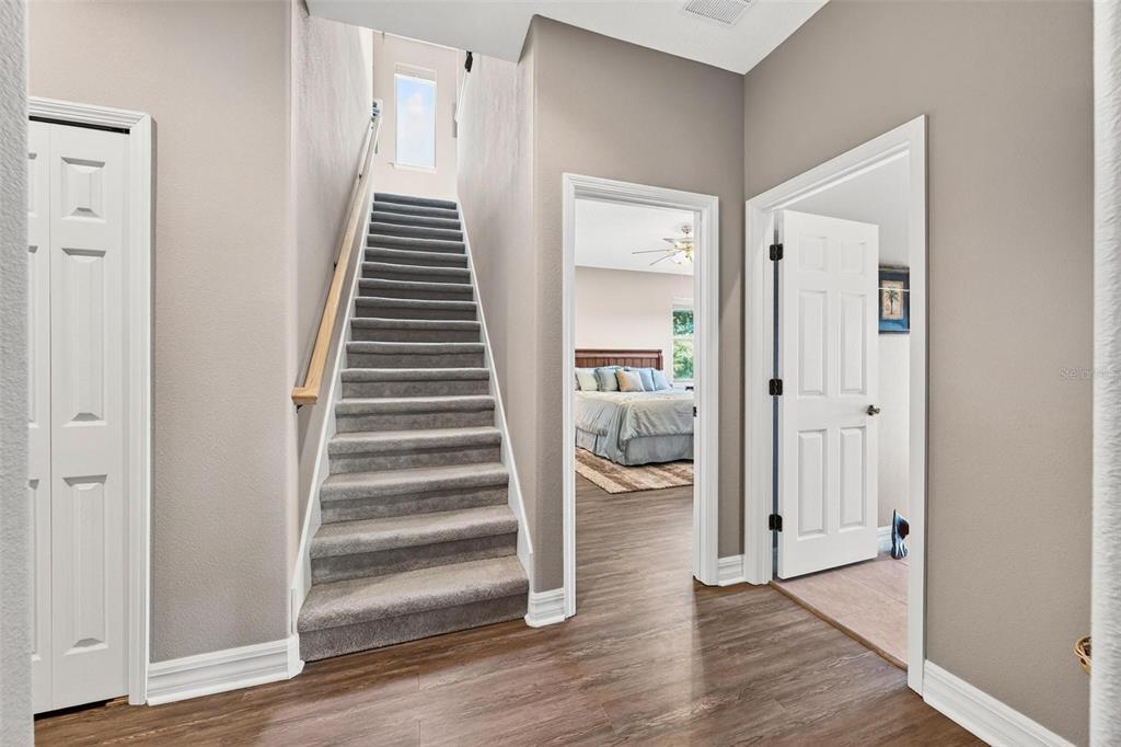 19850 Sugarloaf Mountain Road Clermont, FL 34715 - Photo 51 of 100 a view of a hallway with wooden floor and entryway