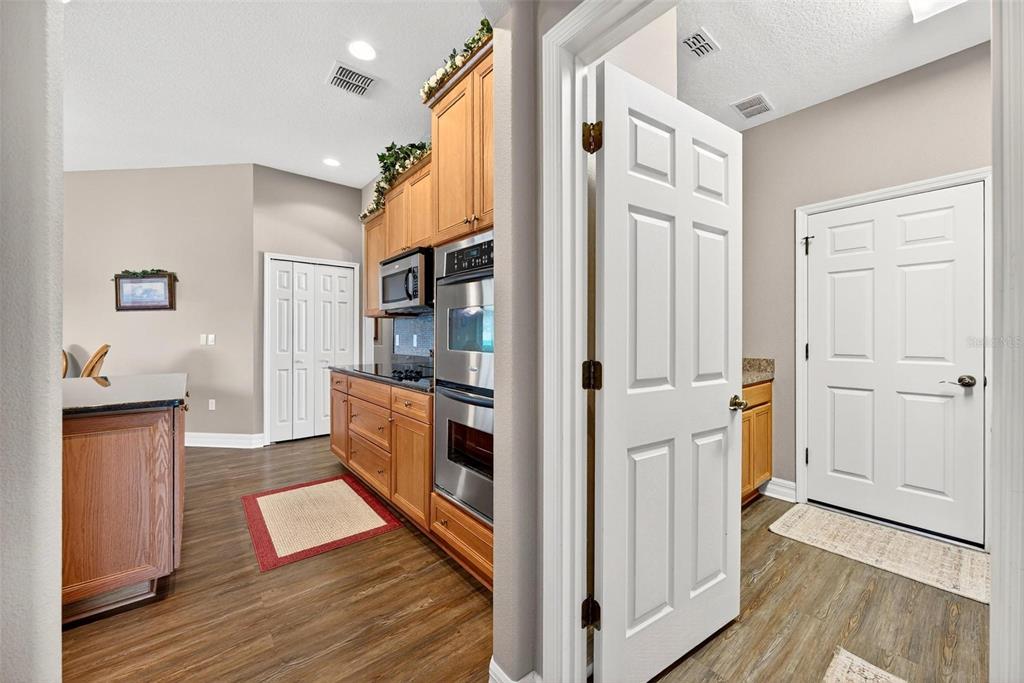 19850 Sugarloaf Mountain Road Clermont, FL 34715 - Photo 62 of 100 a open kitchen with white cabinets and wooden floor