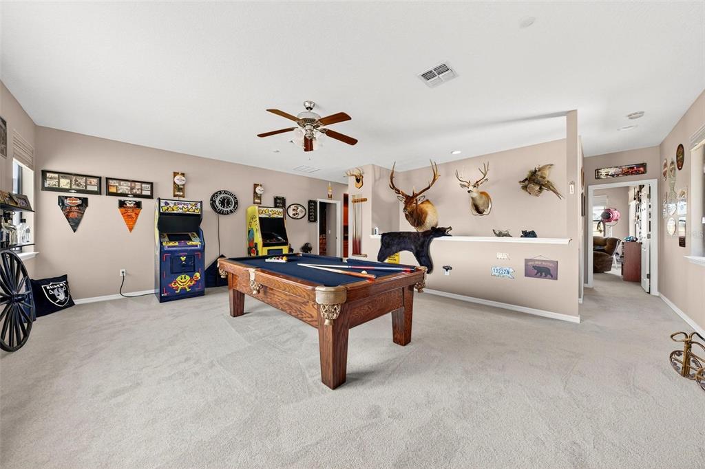 19850 Sugarloaf Mountain Road Clermont, FL 34715 - Photo 74 of 100 a living room with furniture and a flat screen tv