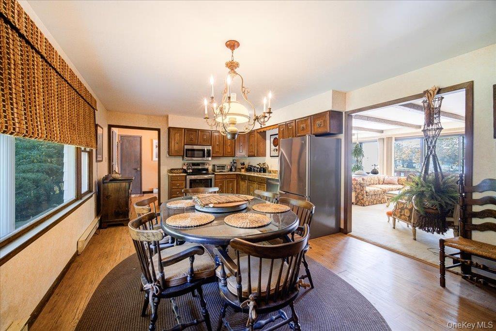 3 Stone Path Rock Hill, NY 12775 - Photo 11 of 33 a dining room with furniture a chandelier and wooden floor