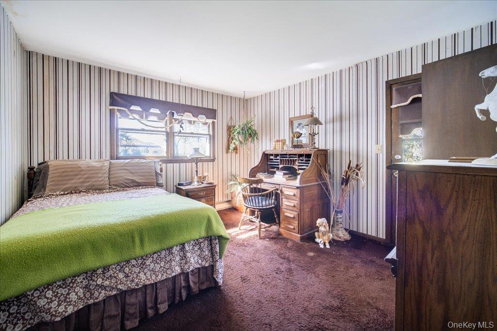 3 Stone Path Rock Hill, NY 12775 - Photo 14 of 33 a bedroom with a bed and a large window