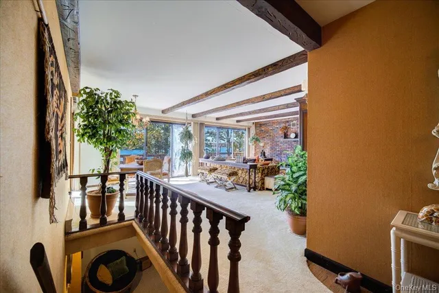 a living room with furniture a window and gym equipment