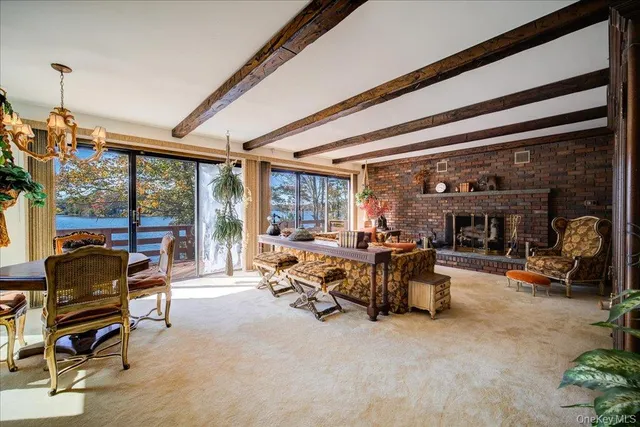 a living room with furniture large window and a fireplace