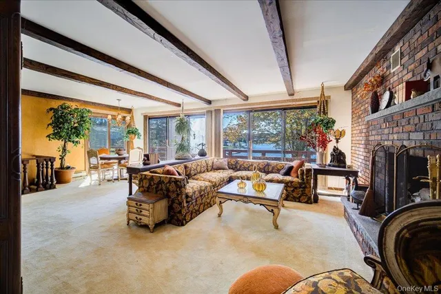 a living room with furniture a rug and a large window