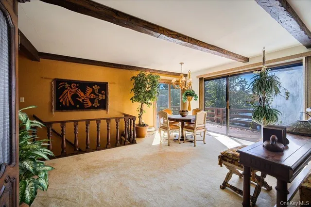 a living room with patio furniture and a floor to ceiling window