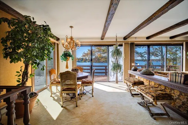 a dining room with furniture a chandelier and wooden floor