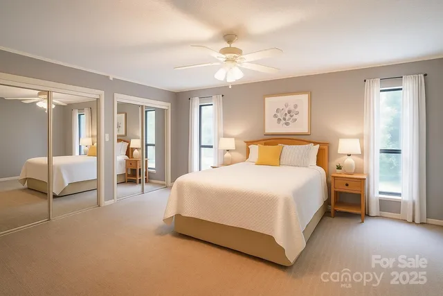 a bedroom with a large bed and a chandelier