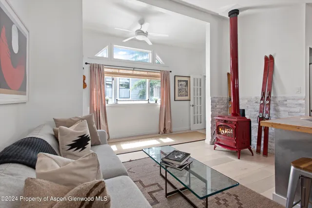 a living room with furniture a window and a chandelier
