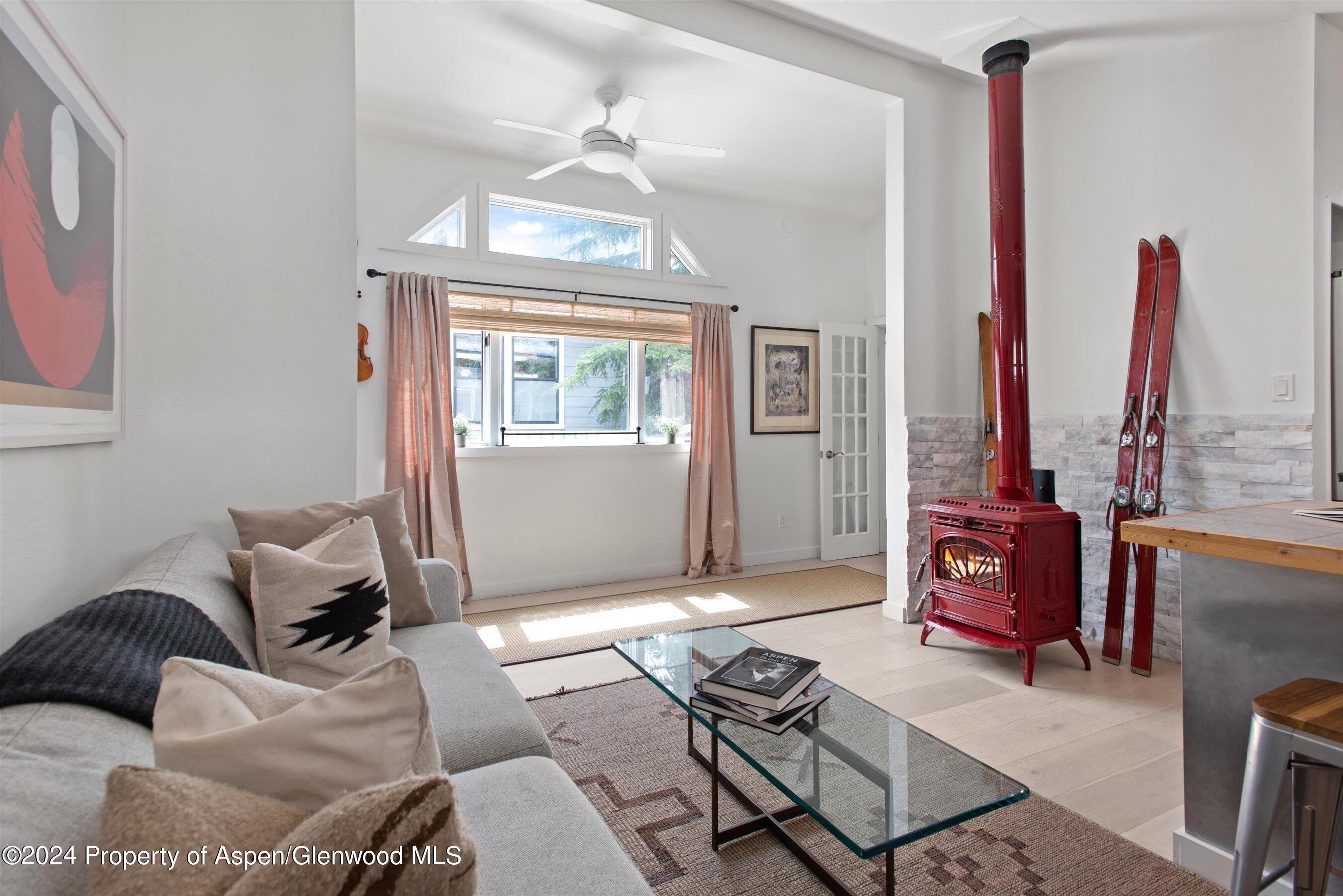 140 Maple Lane Aspen, CO 81611 - Photo 11 of 37 a living room with furniture a window and a chandelier