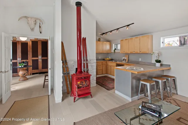 a room with furniture a flat screen tv and a table