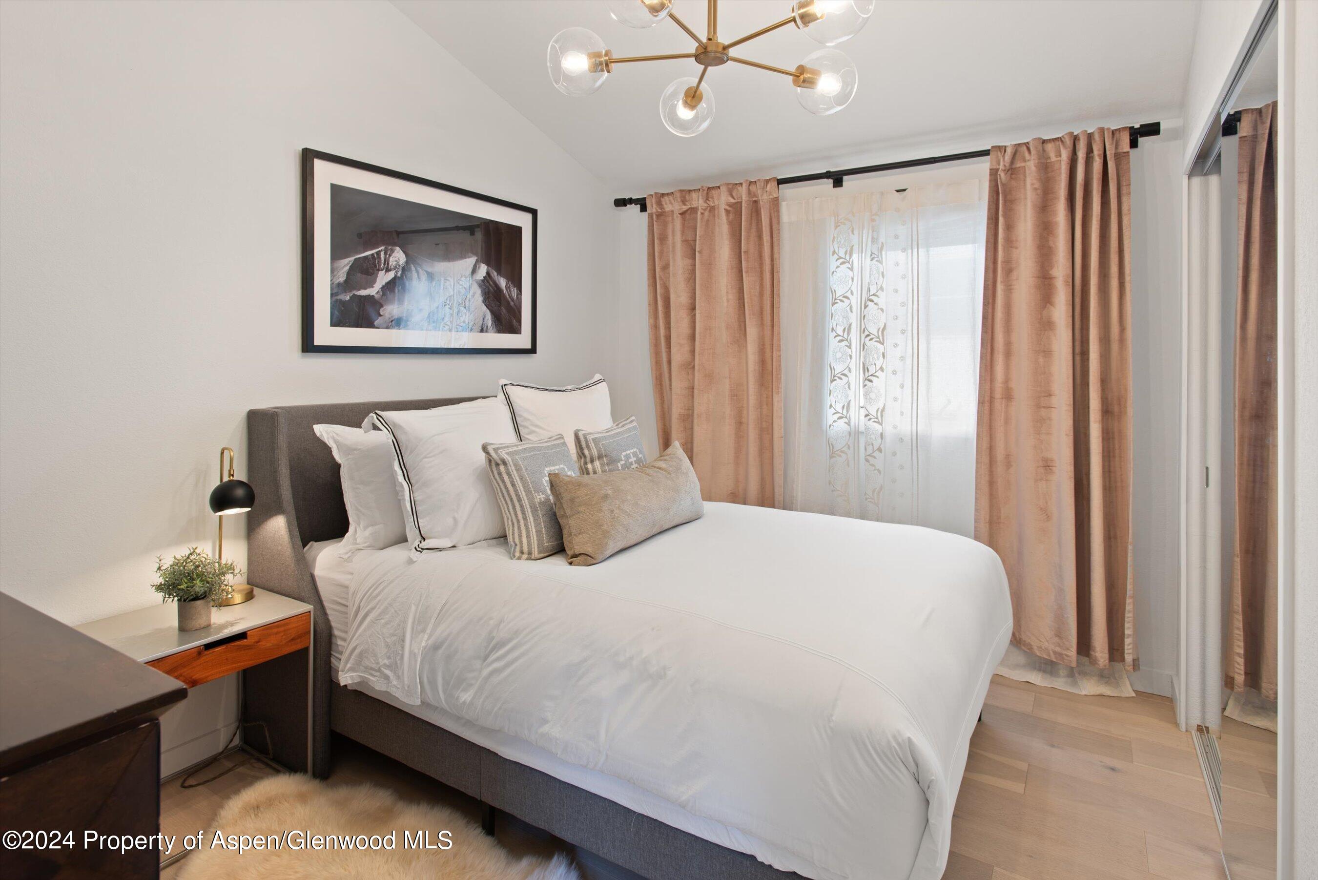 140 Maple Lane Aspen, CO 81611 - Photo 16 of 37 a bedroom with bed and a window