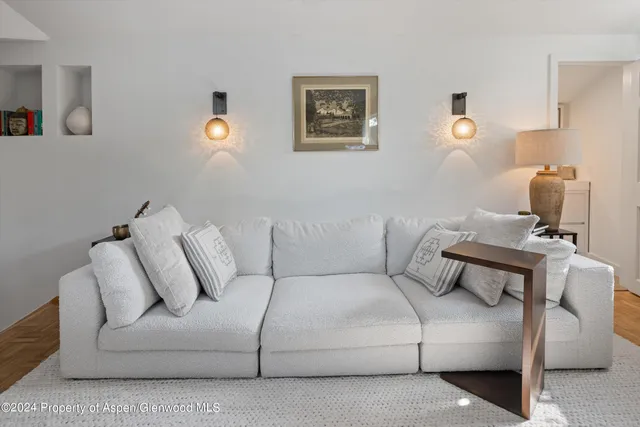 a living room with furniture a piano and a flat screen tv