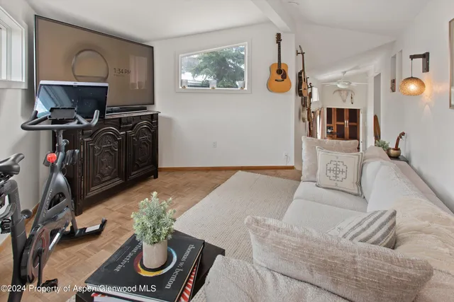 a living room with furniture and a flat screen tv