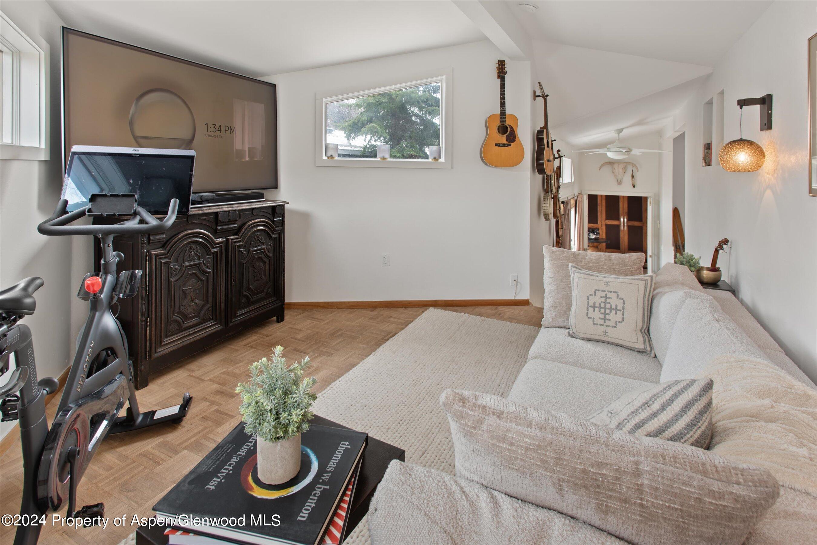 140 Maple Lane Aspen, CO 81611 - Photo 20 of 37 a living room with furniture a piano and a flat screen tv
