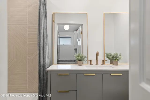 a bedroom with a bed and a night stand