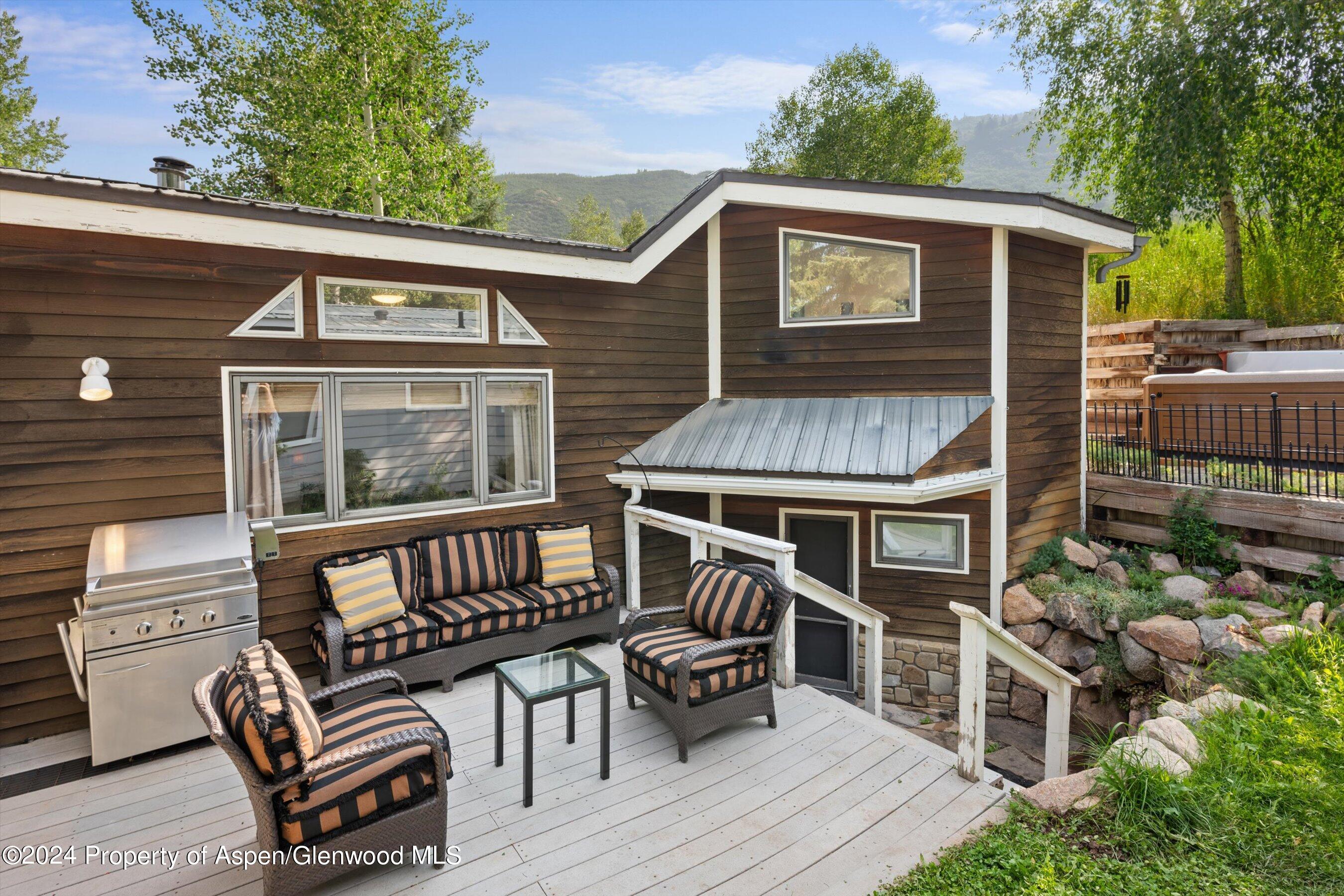 140 Maple Lane Aspen, CO 81611 - Photo 3 of 37 a view of a patio with a table and chairs