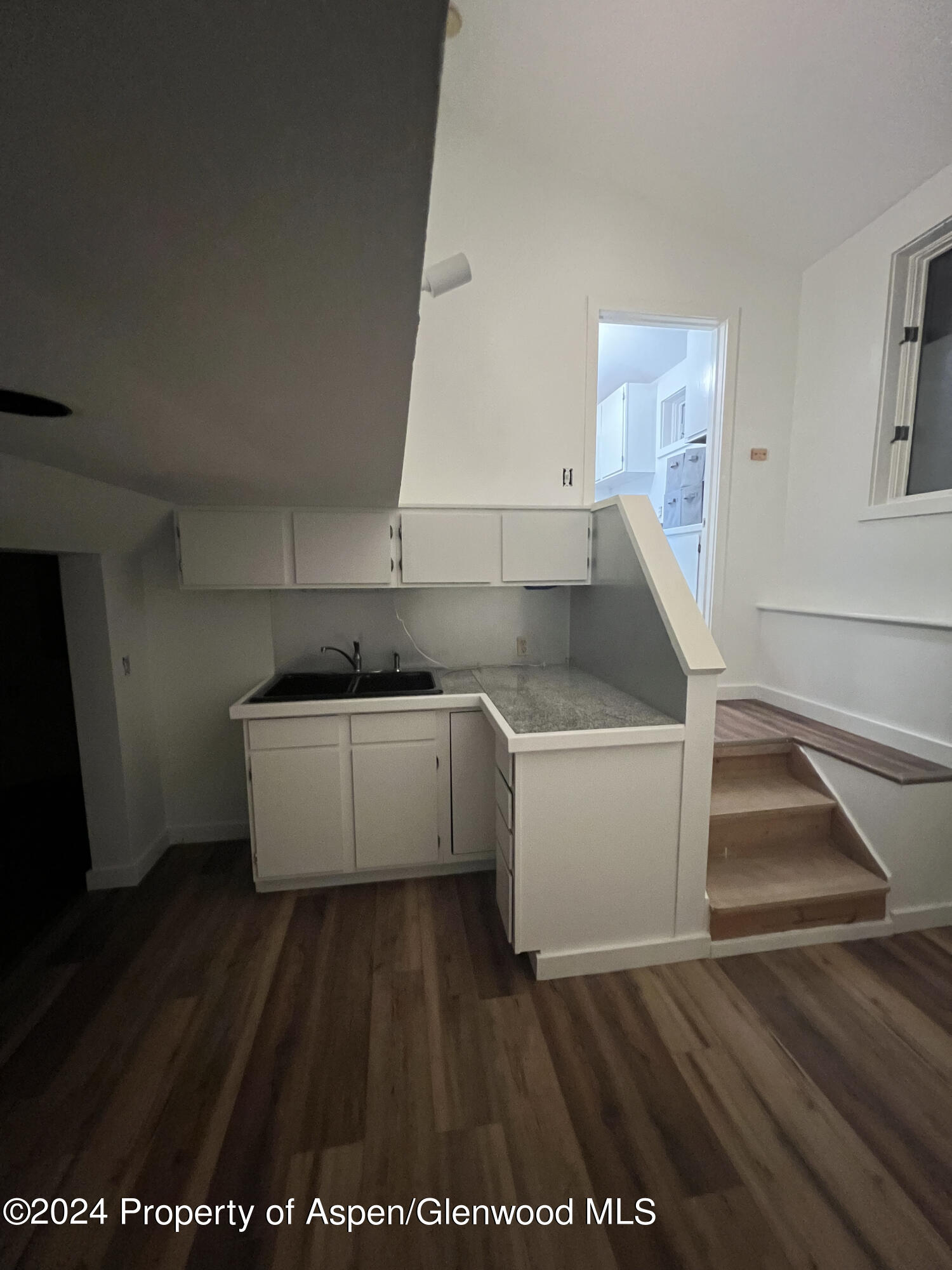 140 Maple Lane Aspen, CO 81611 - Photo 31 of 37 a kitchen with a white stove top oven and sink