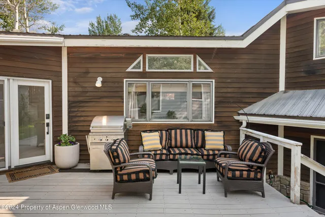 a backyard of a house with potted plants and trees