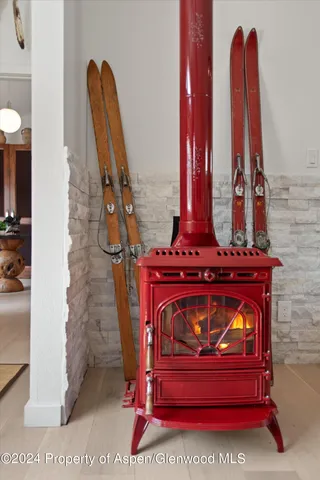 a view of a wooden floor with a small kitchen
