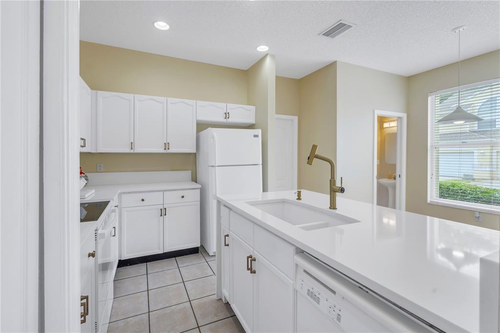 1050 Starkey Road, Unit 2201 Largo, FL 33771 - Photo 12 of 66 a kitchen with white cabinets and refrigerator
