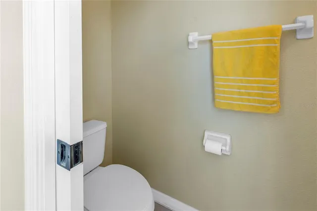 a bathroom with a sink a toilet and a large mirror