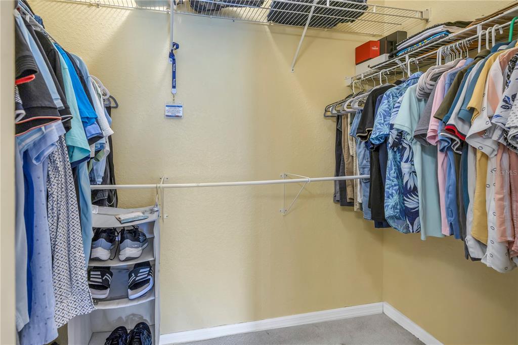 1050 Starkey Road, Unit 2201 Largo, FL 33771 - Photo 44 of 66 a view of walk in closet with clothes and shoes