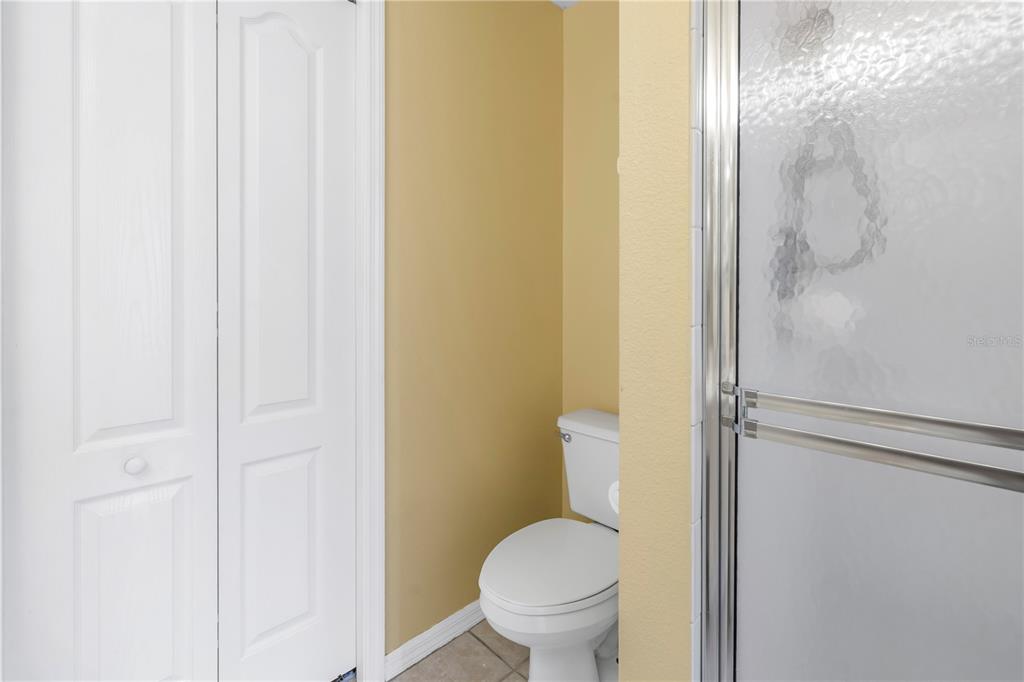 1050 Starkey Road, Unit 2201 Largo, FL 33771 - Photo 45 of 66 a white toilet sitting next to a shower curtain
